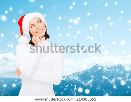 christmas, holidays, winter, happiness and people concept - thinking and smiling woman in santa helper hat over snowy mountains background