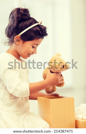 holidays, presents, christmas, birthday concept - happy child girl with gift box and teddy bear