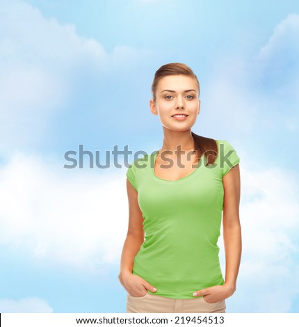t-shirt design and people concept - smiling young woman in blank green t-shirt