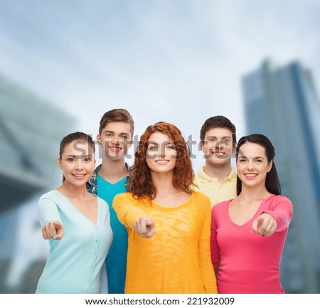 friendship, city life, business and people concept - group of smiling teenagers over city background