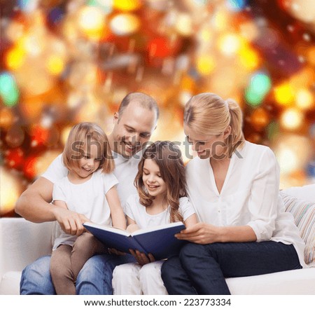 family, childhood, holidays and people - smiling mother, father and little girls reading book over red lights background