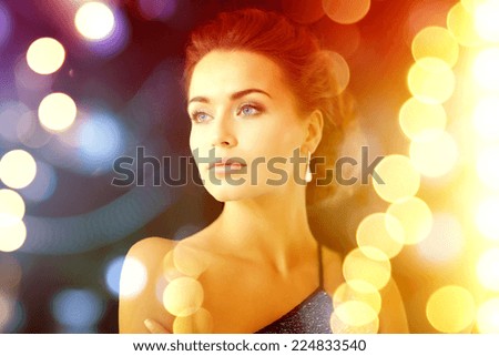 jewelry, luxury, vip, nightlife, party concept - beautiful woman in evening dress wearing diamond earrings