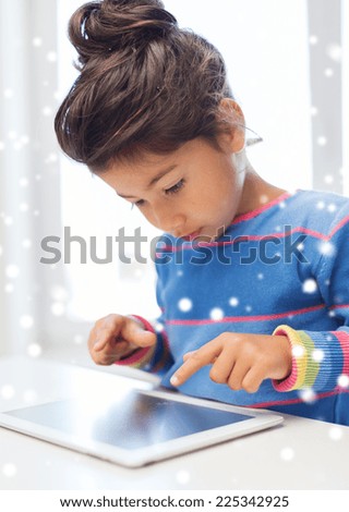 education, winter, technology and people concept - little girl with tablet pc at home