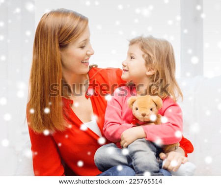 family, childhood, holidays and people concept - happy mother and daughter with teddy bear toy