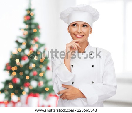 cooking, holidays and people concept - smiling female chef, cook or baker dreaming over living room and christmas tree background