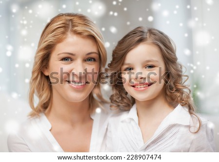 people, motherhood, family, winter and adoption concept - happy mother and daughter
