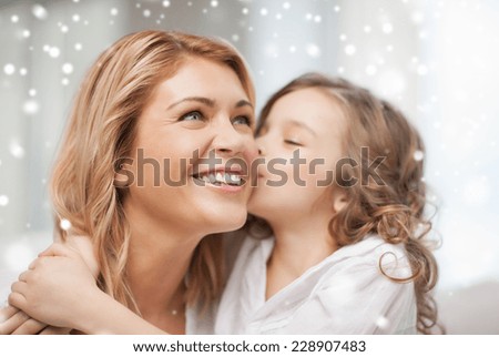 people, motherhood, family, winter and adoption concept - happy mother and daughter hugging and kissing at home