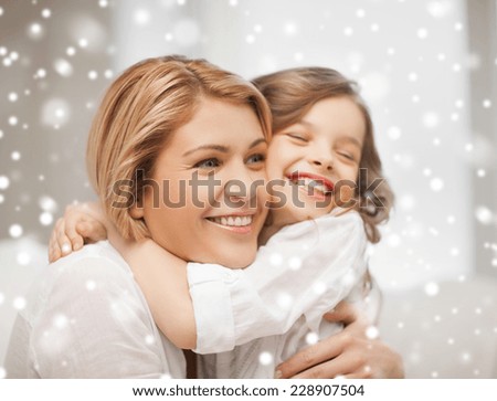 people, motherhood, family, winter and adoption concept - happy mother and daughter hugging at home