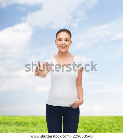 advertising, summer vacation, gesture and people concept - smiling young woman in blank white t-shirt showing thumbs up over natural background