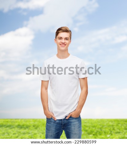 t-shirt design, summer, advertising and people concept - smiling young man in blank white t-shirt over natural background