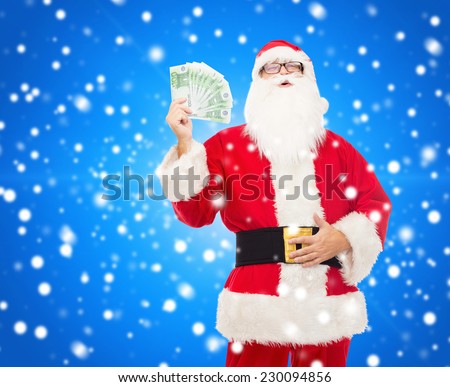 christmas, holidays, winning, currency and people concept - man in costume of santa claus with euro money over blue snowy background