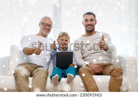 family, generation, technology and people concept - smiling father, son and grandfather sitting on couch with tablet pc computer showing thumbs up gesture at home
