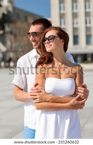 love, wedding, summer, dating and people concept - smiling couple wearing sunglasses hugging in city