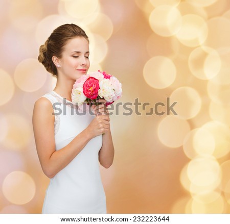 people, wedding, holidays and celebration concept - smiling bride or bridesmaid in white dress with bouquet of flowers over beige lights background