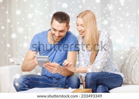 tax, finances, family, home and people concept - happy couple with papers and calculator at home