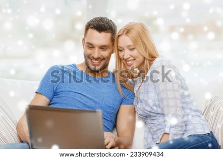 love, family, technology, internet and happiness concept - smiling happy couple with laptop computer at home