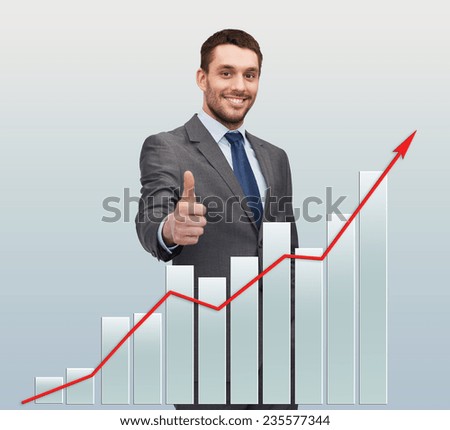 business, gesture and people concept - smiling handsome businessman showing thumbs up over gray background with graph