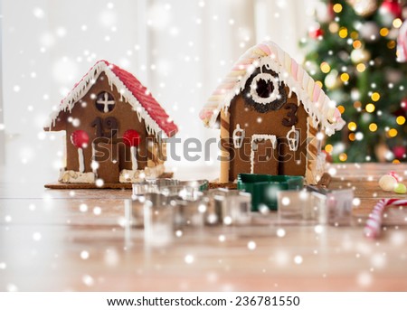 holidays, christmas, baking and sweets concept - closeup of beautiful gingerbread houses at home
