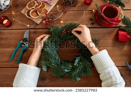 Similar – Image, Stock Photo Woman making Christmas wreath of spruce, step by step. Concept of florist’s work before the Christmas holidays.