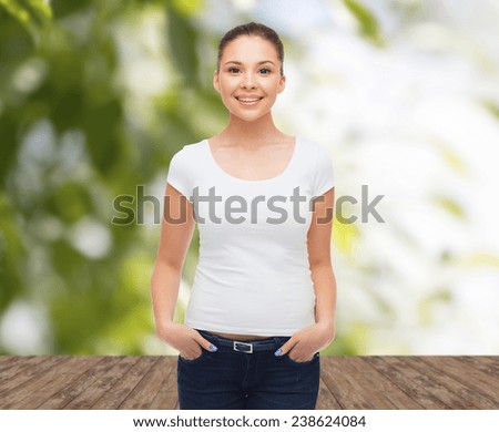 advertising, nature, ecology, summer vacation and people concept - smiling young woman in blank white t-shirt over wooden floor and green plants background