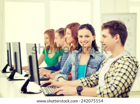 education, technology and internet - smiling female student with computer studying at school