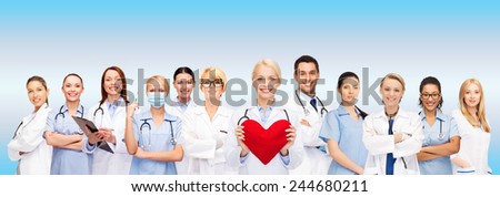 healthcare and medicine concept - smiling doctors and nurses with red heart