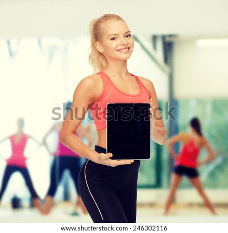 fitness, dieting, technology and sport concept - smiling sporty woman showing tablet pc blank black screen