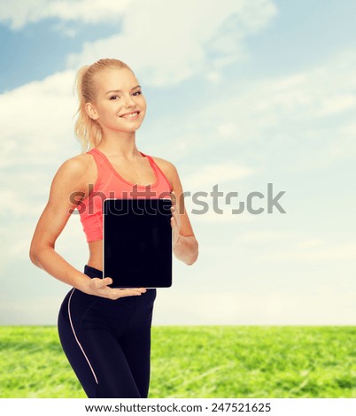 fitness, dieting, technology and sport concept - smiling sporty woman showing tablet pc blank black screen