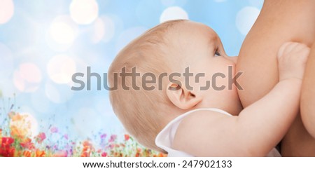 motherhood, children, people and care concept - close up of mother breast feeding adorable baby over blue sky with lights and poppy field background
