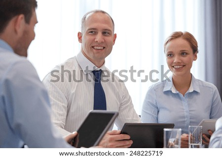 business, conference, people, technology and teamwork concept - smiling businessmen and businesswoman with tablet pc computer meeting in office