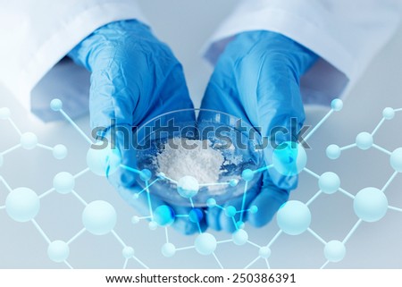 science, chemistry, biology, medicine and people concept - close up of scientist hands holding petri dish with powder in clinical laboratory
