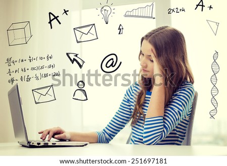 home, education, technology and internet concept - tired teenage girl with laptop computer sitting at table at home