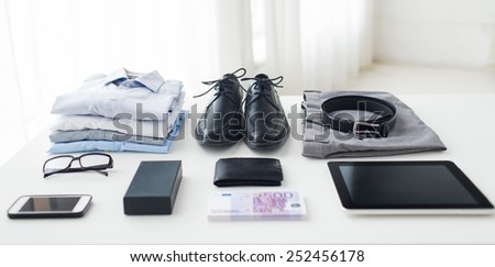 business, style, clothes and objects concept - close up of formal male clothes and personal stuff on table at home