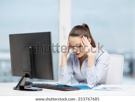 business, office, school and education concept - stressed businesswoman with computer and documents at work