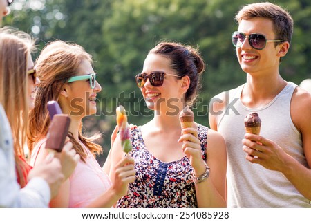 friendship, leisure, sweets, summer and people concept - group of smiling friends with ice cream outdoors