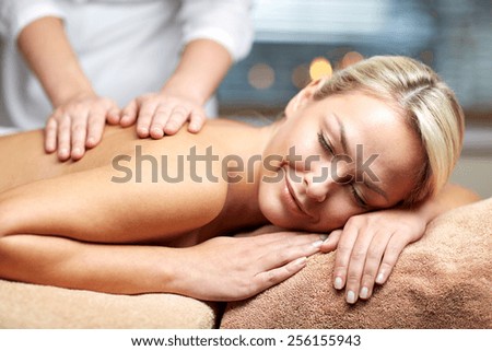people, beauty, spa, healthy lifestyle and relaxation concept - close up of beautiful young woman lying with closed eyes and having hand massage in spa