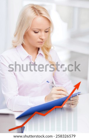 education, business and people concept - businesswoman or student with clipboard and growing graph writing and taking notes in office