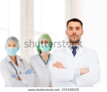 healthcare, profession and medicine concept - male doctor in white coat over white background