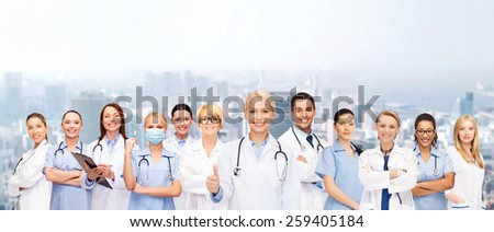 medicine and healthcare concept - team or group of doctors and nurses showing thumbs up