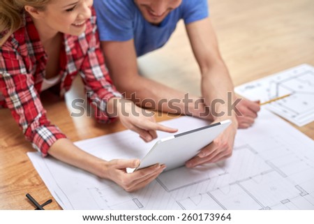 repair, building, renovation, architecture and technology concept - close up of couple with tablet pc and blueprint at home