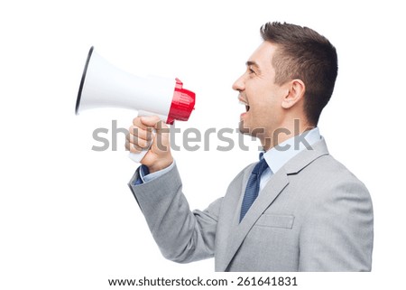 business, people and public announcement concept - happy businessman in suit speaking to megaphone