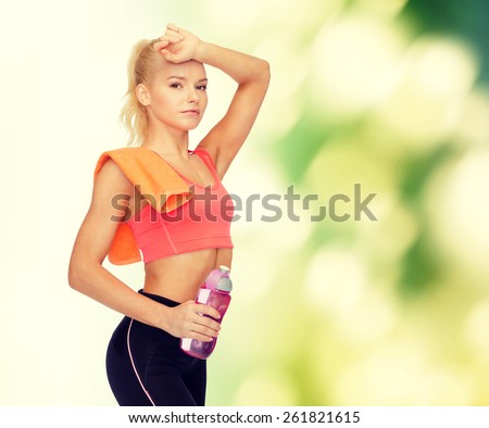 sport, exercise and healthcare concept - tired sporty woman with orange towel and water bottle