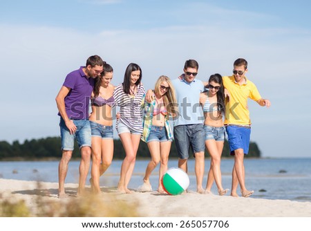 summer holidays, vacation, tourism, travel and people concept - group of happy friends with inflatable ball walking along beach