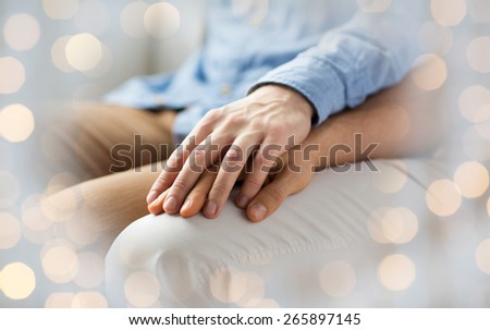 people, homosexuality, same-sex marriage, gay and love concept - close up of happy male gay couple holding hands