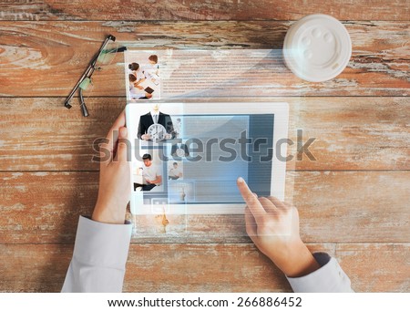 business, people, social network and technology concept - close up of hands pointing finger to tablet pc computer screen with internet article, coffee cup and eyeglasses on table