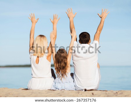 summer holidays, celebration, children and people concept - happy family at the seaside with greeting gesture