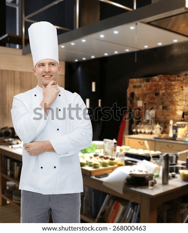 cooking, profession, inspiration and people concept - happy male chef cook thinking over restaurant kitchen