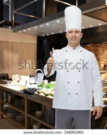 cooking, profession, gesture and people concept - happy male chef cook showing thumbs up over restaurant kitchen