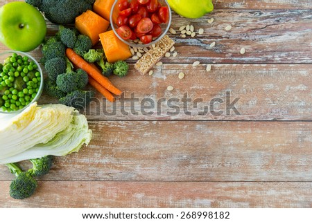 healthy eating, vegetarian food, advertisement and culinary concept - close up of ripe vegetables on wooden table