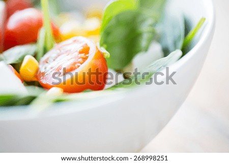 healthy eating, dieting, vegetarian kitchen and cooking concept - close up of vegetable salad bowl at home